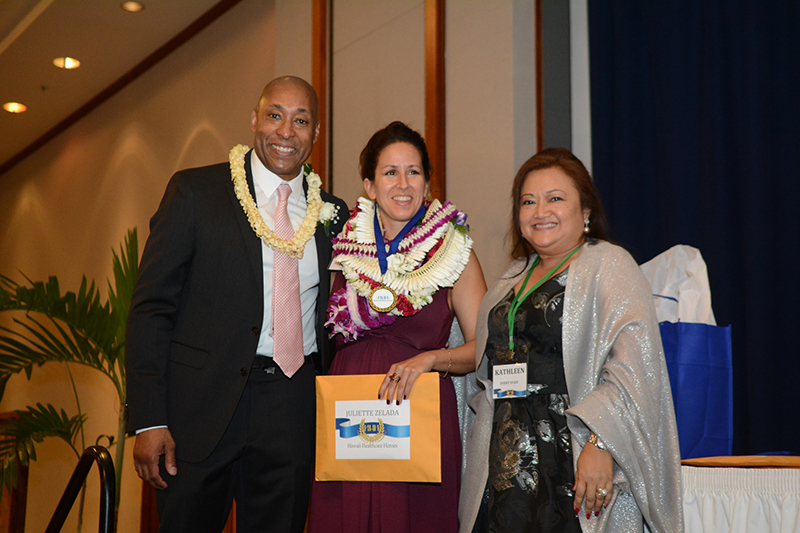 Juliette Zelada and two others at an award ceremony