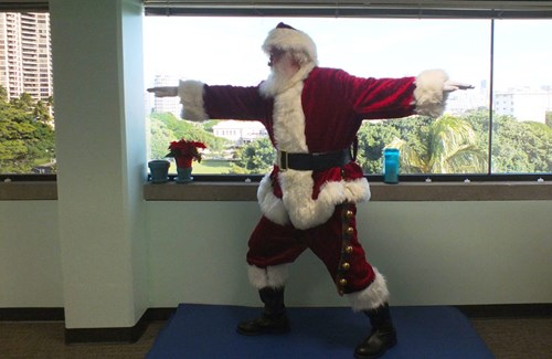 Santa does his best Warrior II pose for better balance and strength in order to slide down all those chimneys.