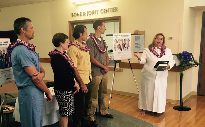 group of people wearing leis at a ceremony