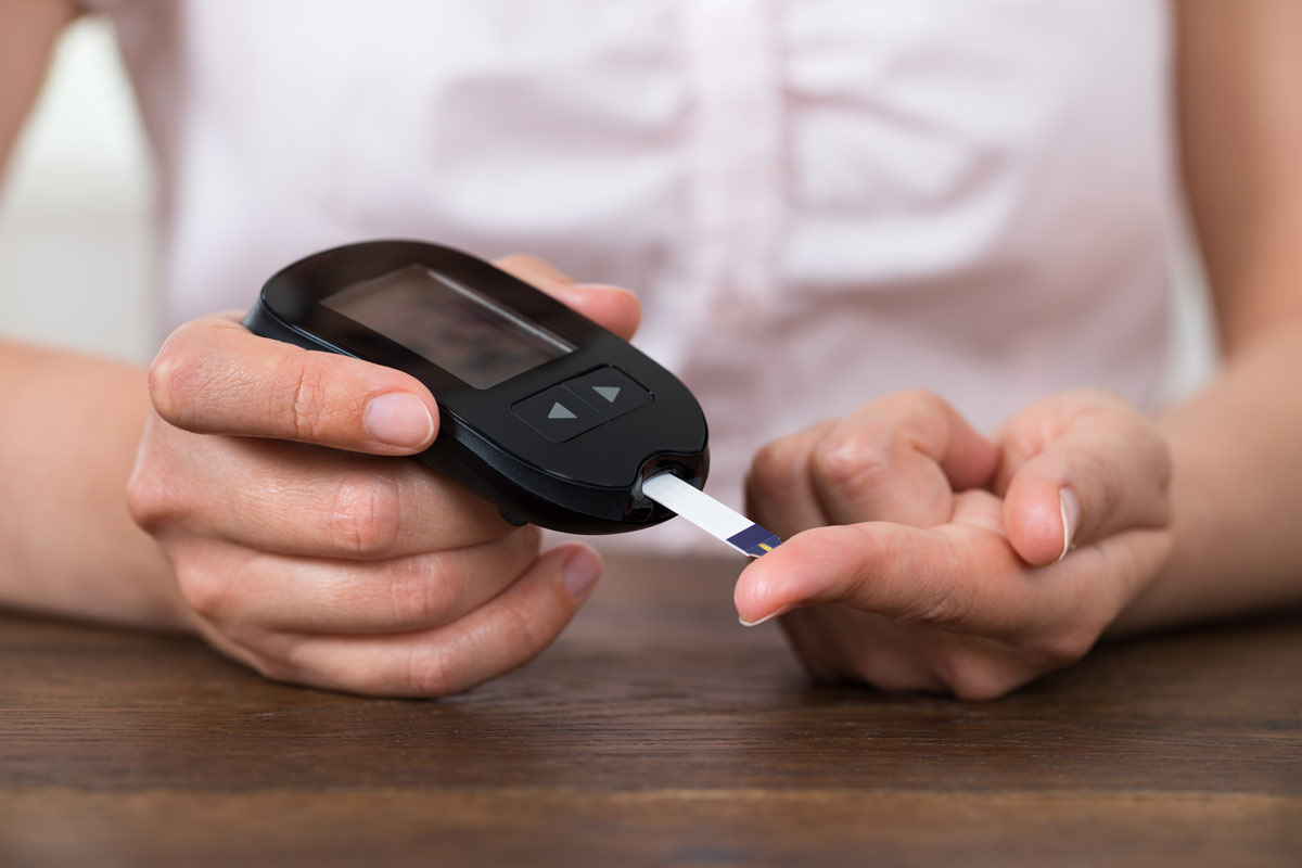 patient testing her blood for diabetes