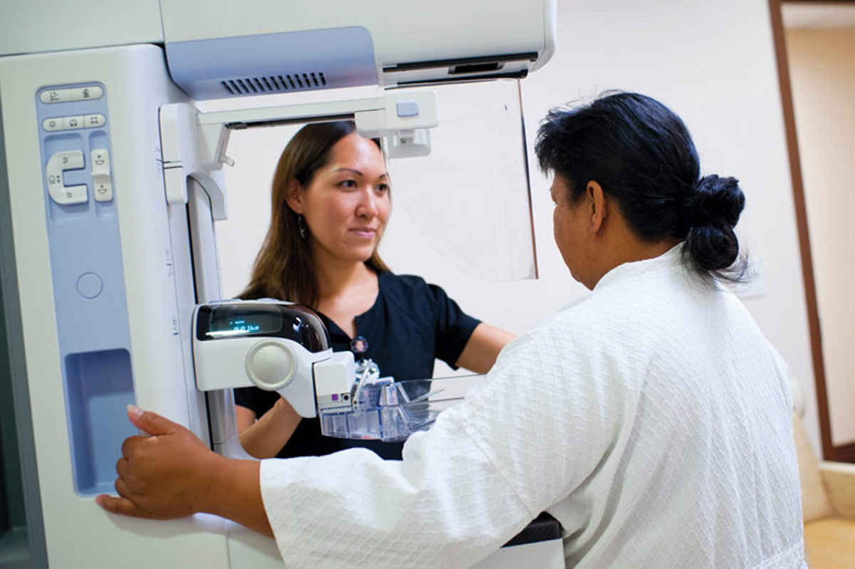 patient getting a mammogram performed by doctor