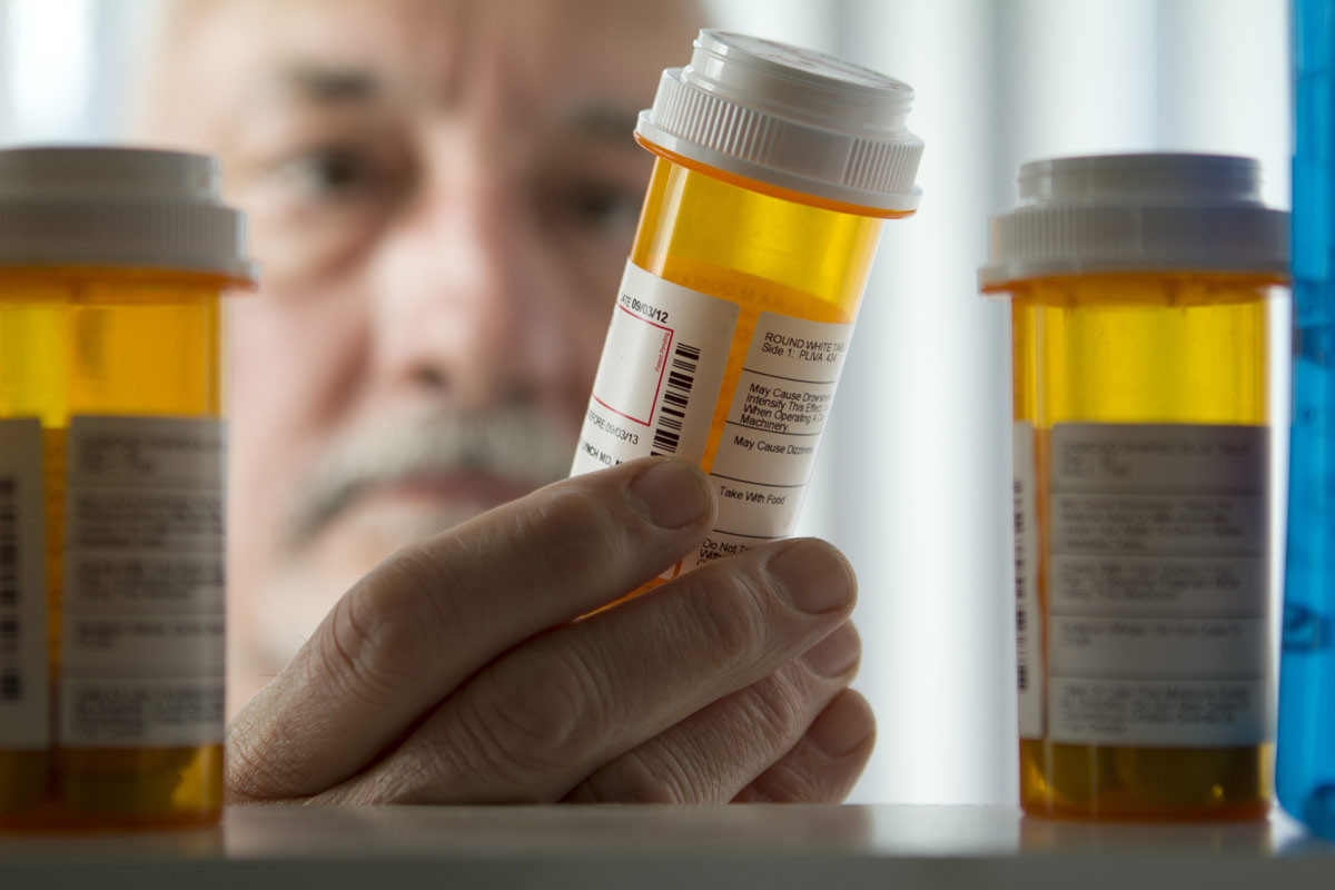 doctor examining the contents of a prescription bottle