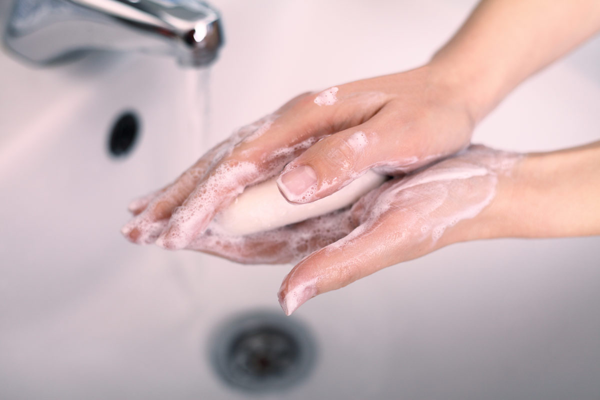 Person washing their hands with soap
