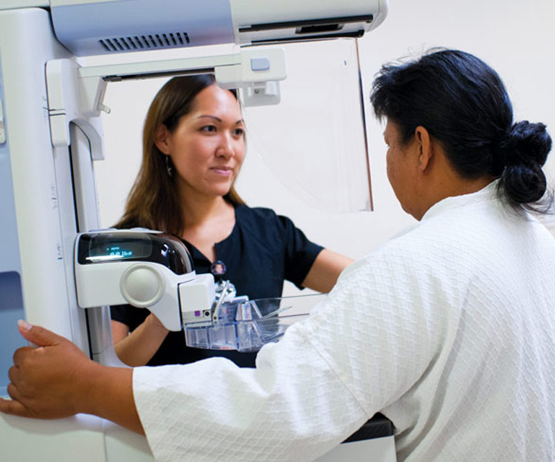 patient getting a mammogram performed by nurse practitioner