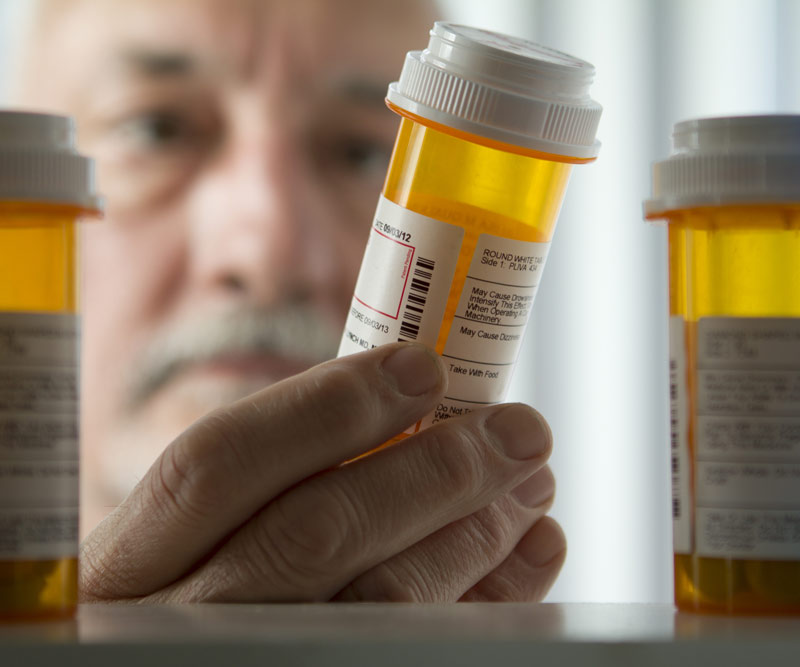 doctor examining the contents of a prescription bottle