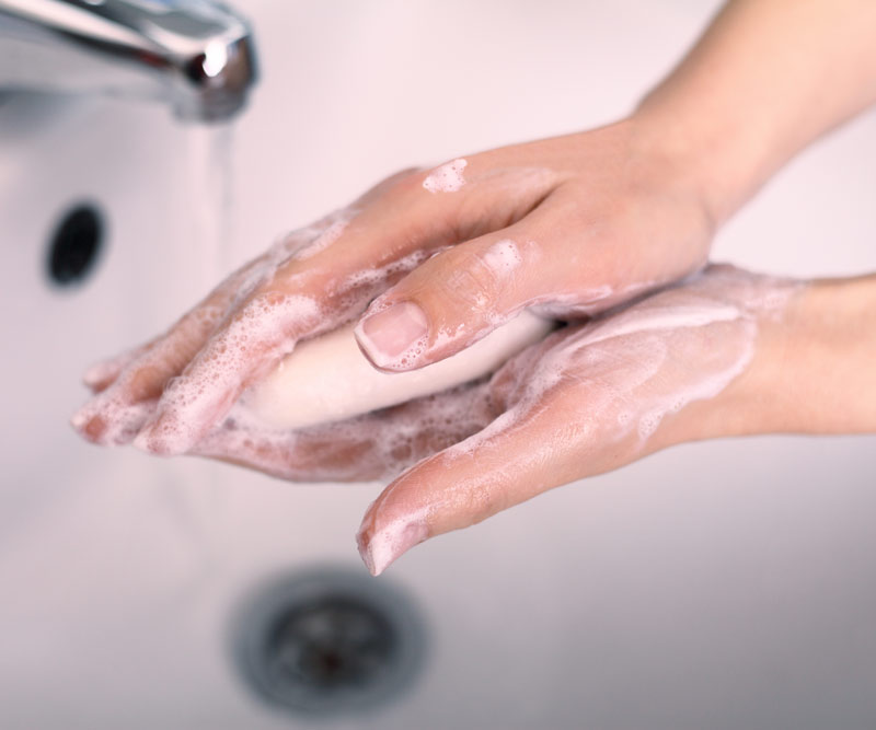 Person washing their hands with soap