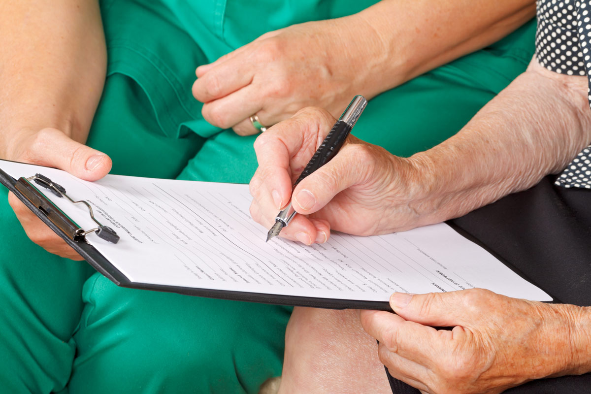 patient and doctor examining a medical form