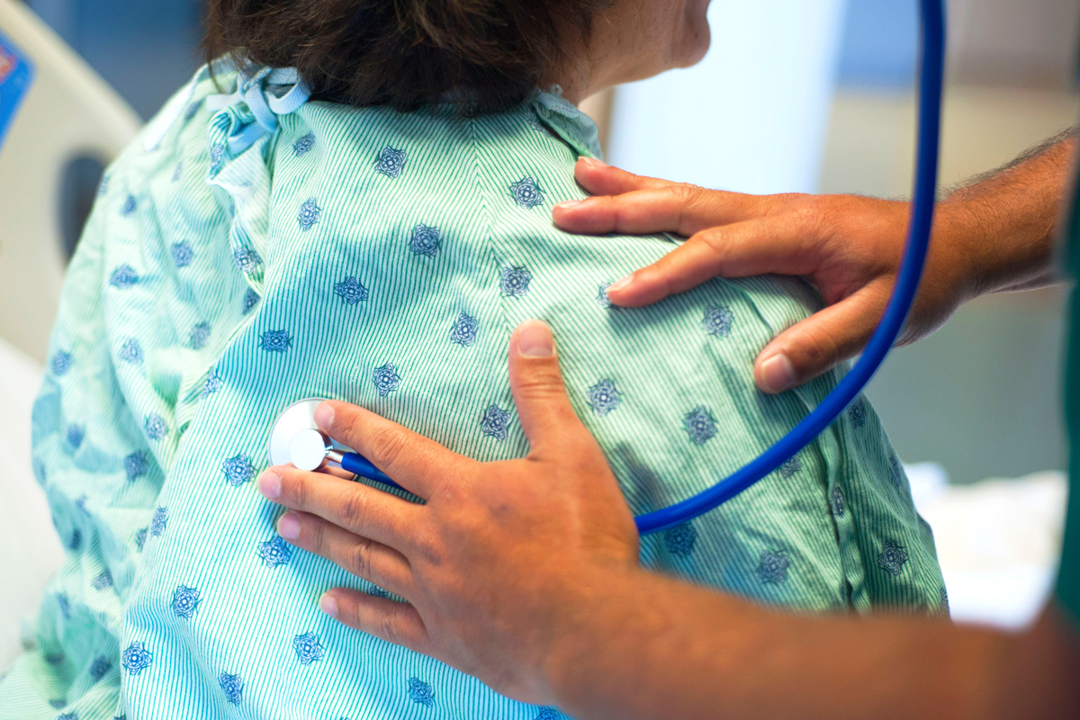 doctor listening to her patients airways through a stethoscope