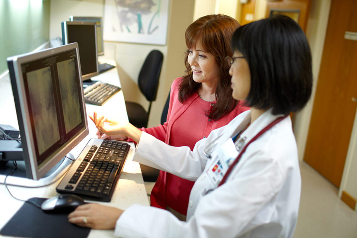 Doctor examining a scan with her patient