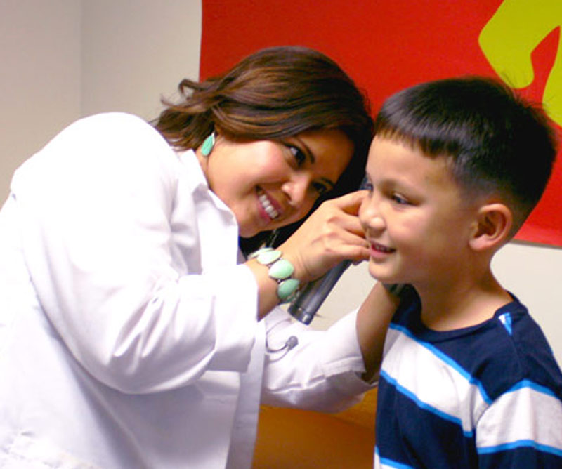 Child getting their ear examined from doctor
