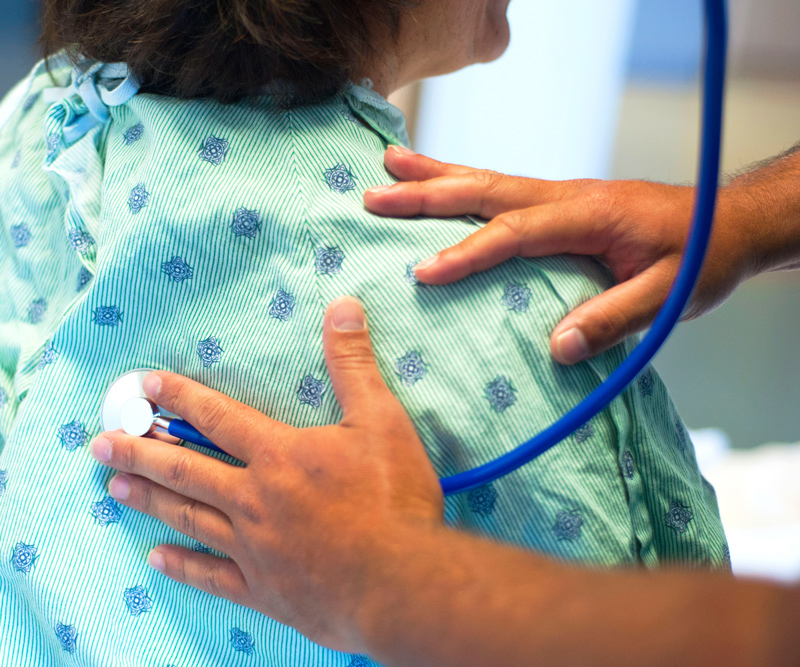 doctor listening to her patients airways through a stethoscope