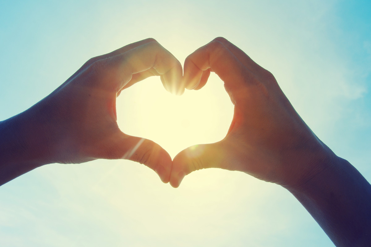 person making a heart sign with their hands