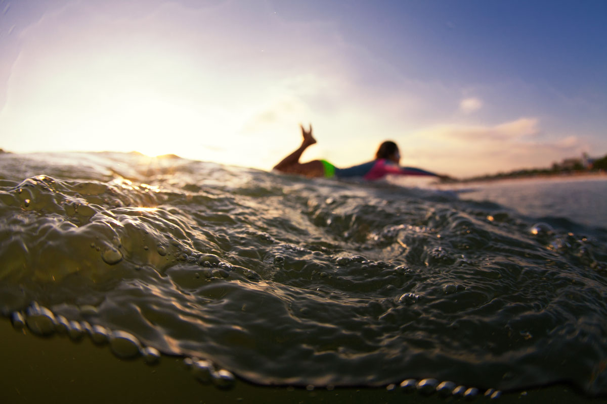 a surfer at sunrise