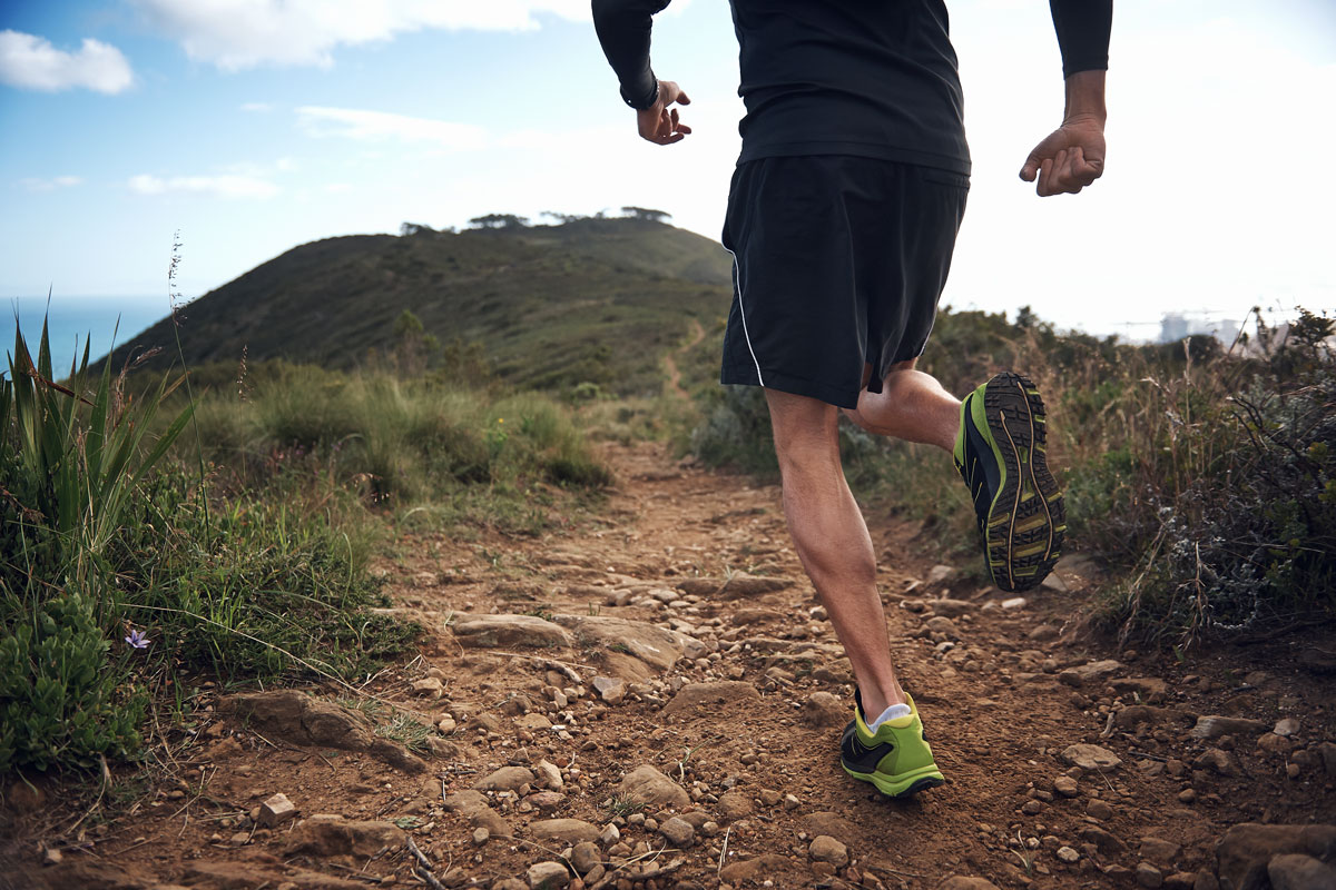 man running on a dirt path