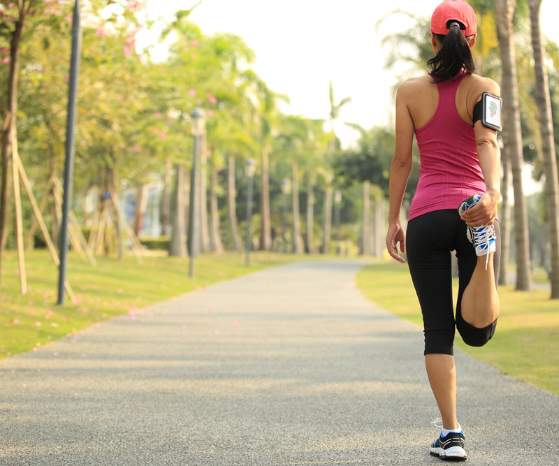 a runner stretching on a path