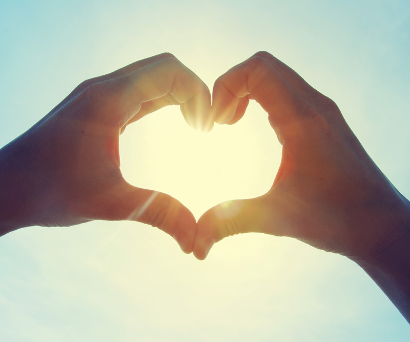 person making a heart sign with their hands