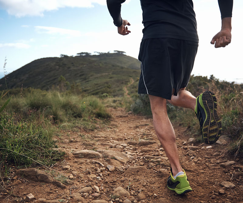 man running on a dirt path