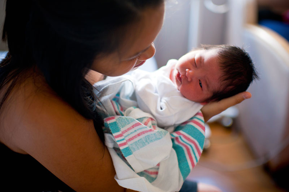 newborn baby in the arms of mom