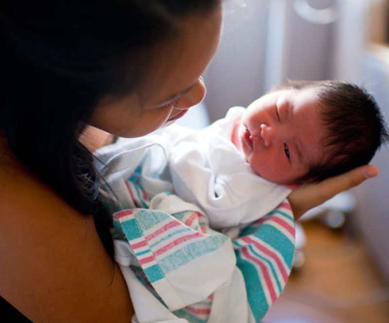 newborn baby in the arms of mom