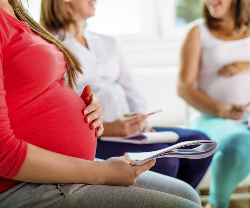 three pregnant women discussing their pregnancies