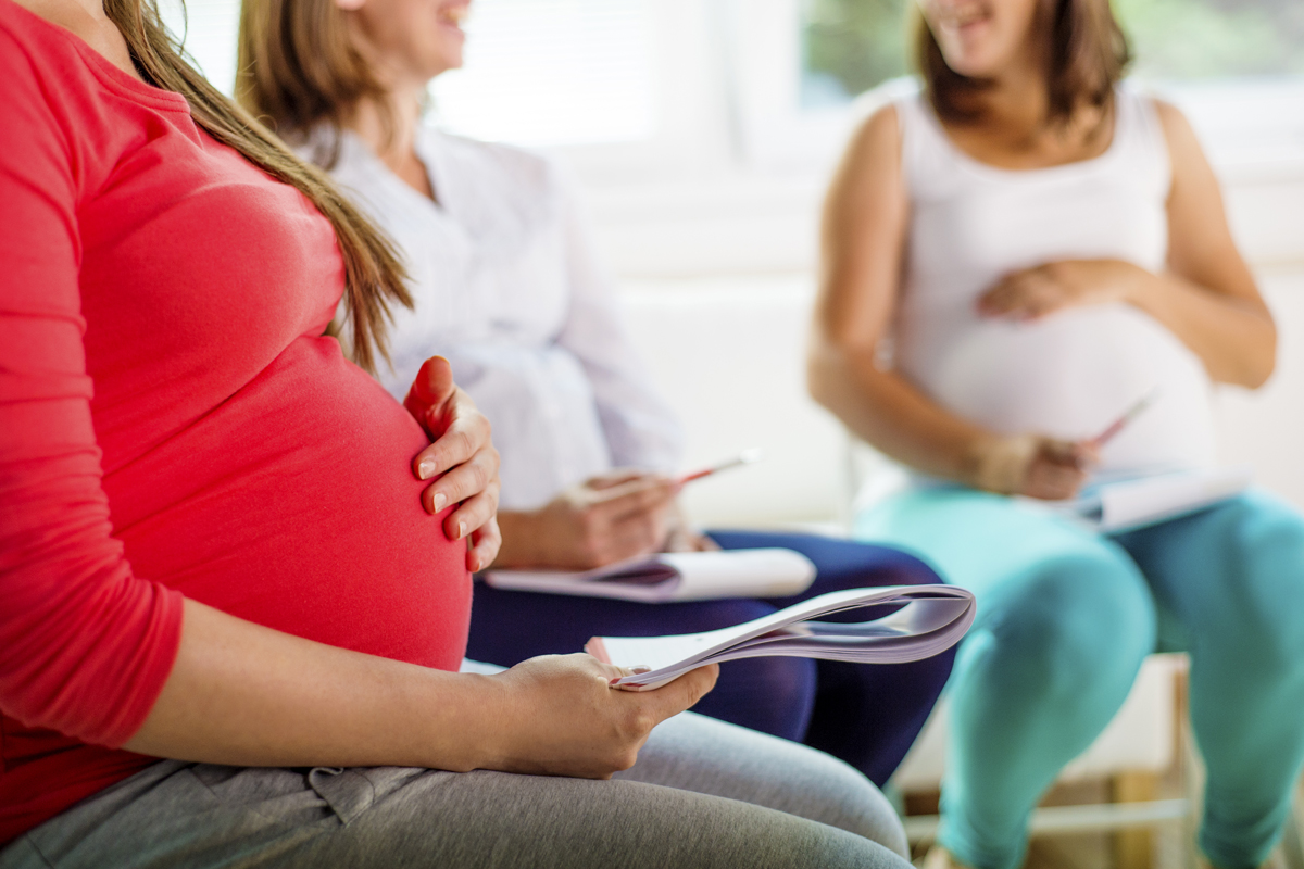three pregnant women discussing their pregnancies