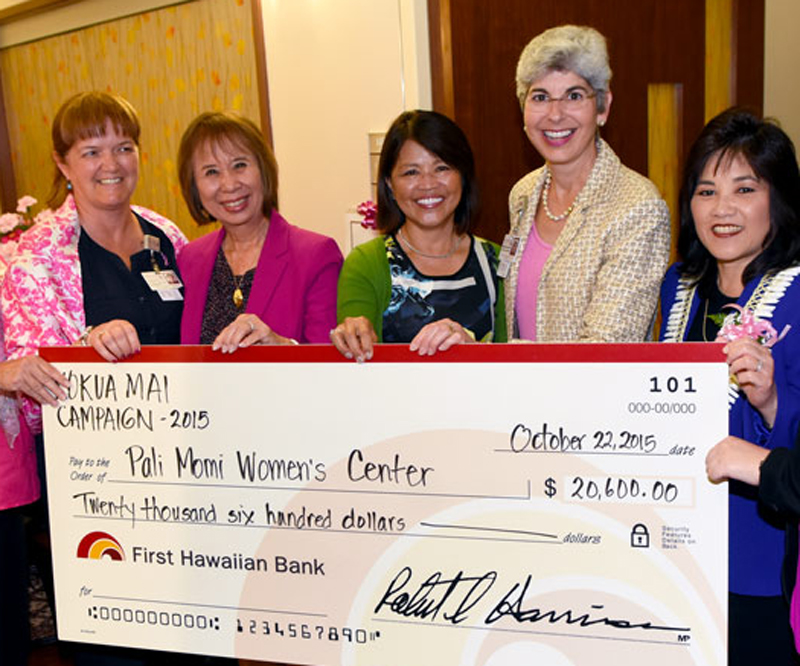 Pali Momi leadership and Women's Center staff holding a check donation from First Hawaiian Bank