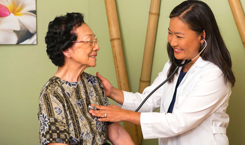 Doctor and patient together using a stethoscope