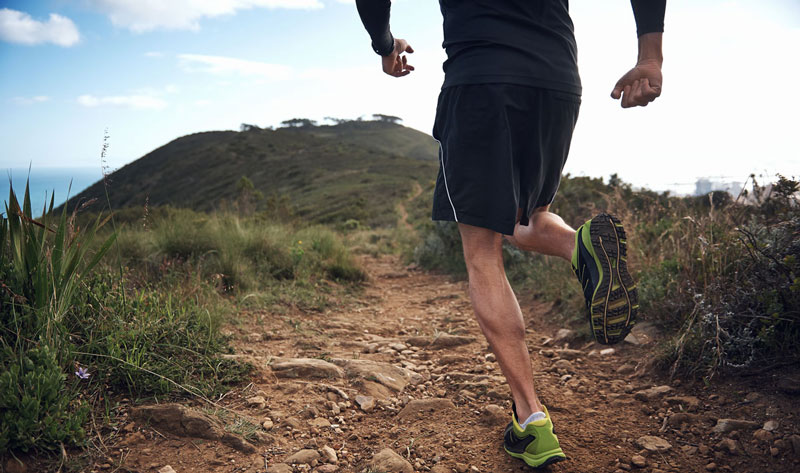 Man running on a mountain trail