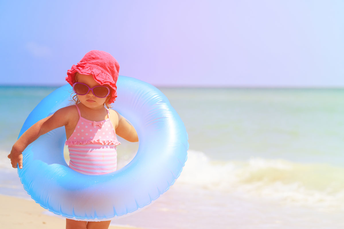 a child holding a flotation device