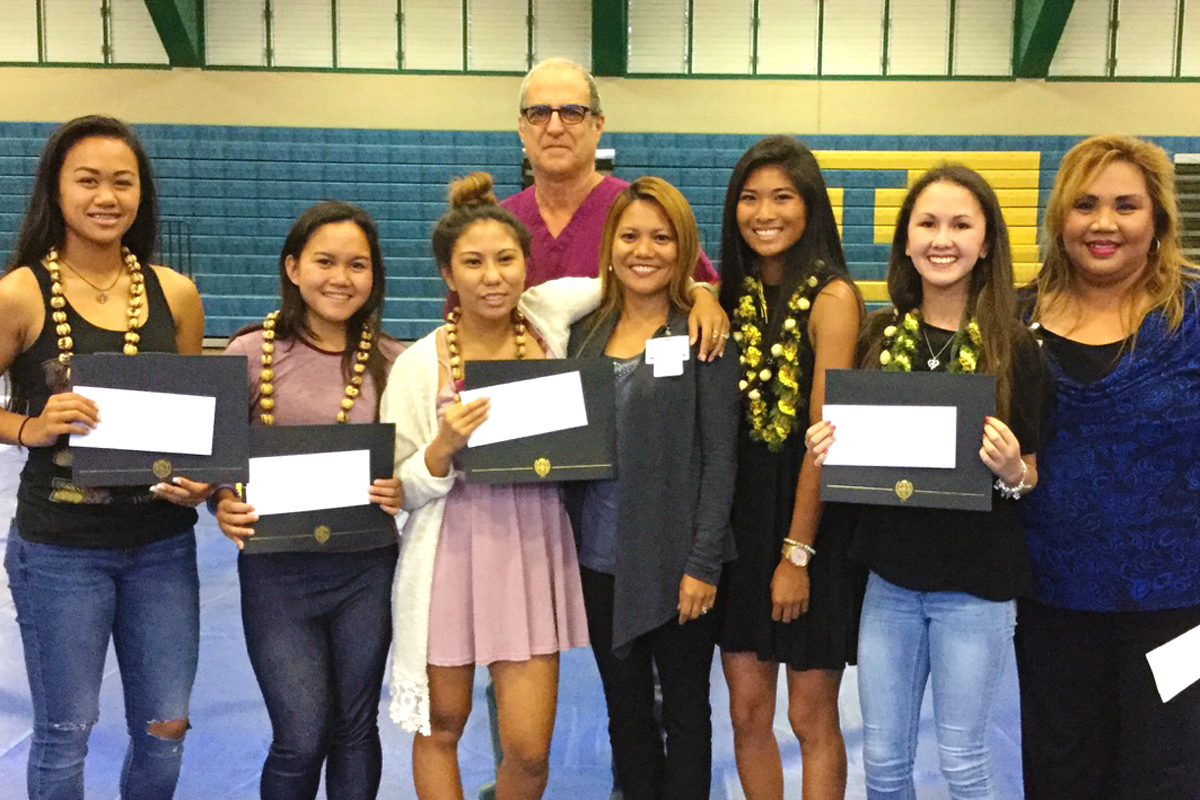 group of high school students with scholarships in hand