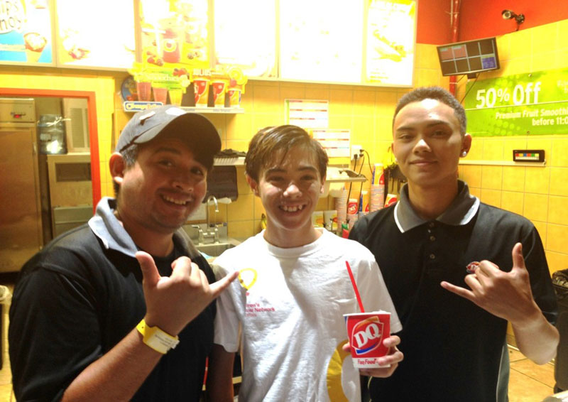 group of three with a dairy queen blizzard doing a shaka sign