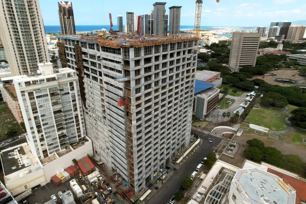 Aerial view of the parking building with the ocean and skyline beyond.