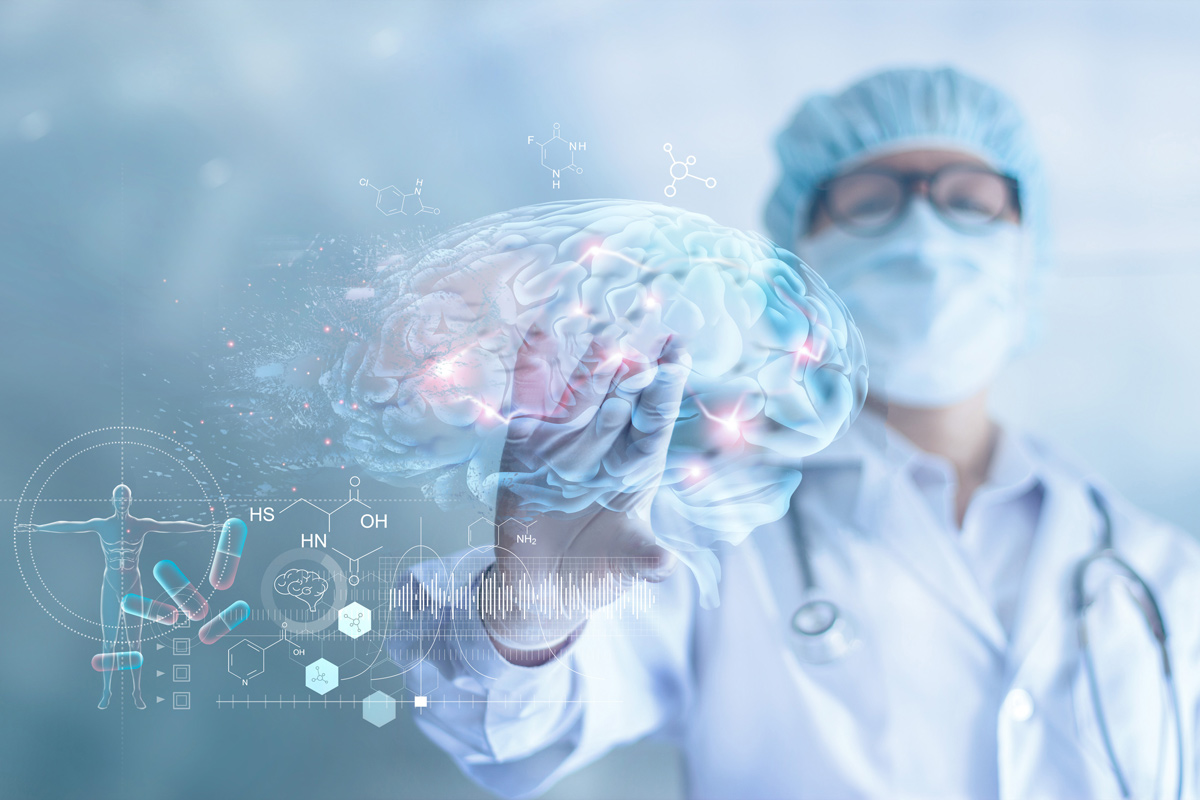 A doctor dressed in scrubs looks at a digital image of a brain with hot spots where neurons are firing.
