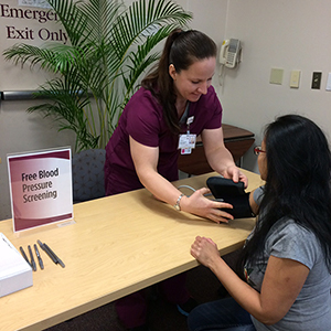 a medical professional checking the blood pressure of a patient