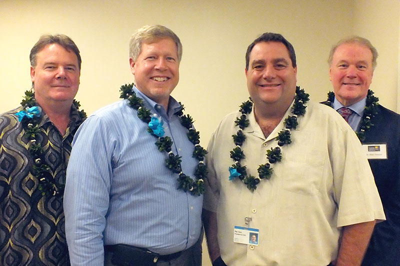 a group of men wearing leis