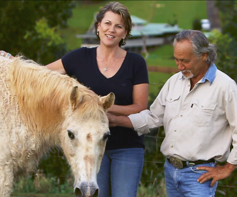 Couple petting their horse