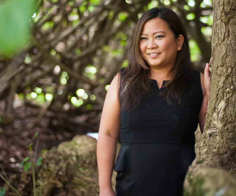 Robyn Polinar leaning against tree