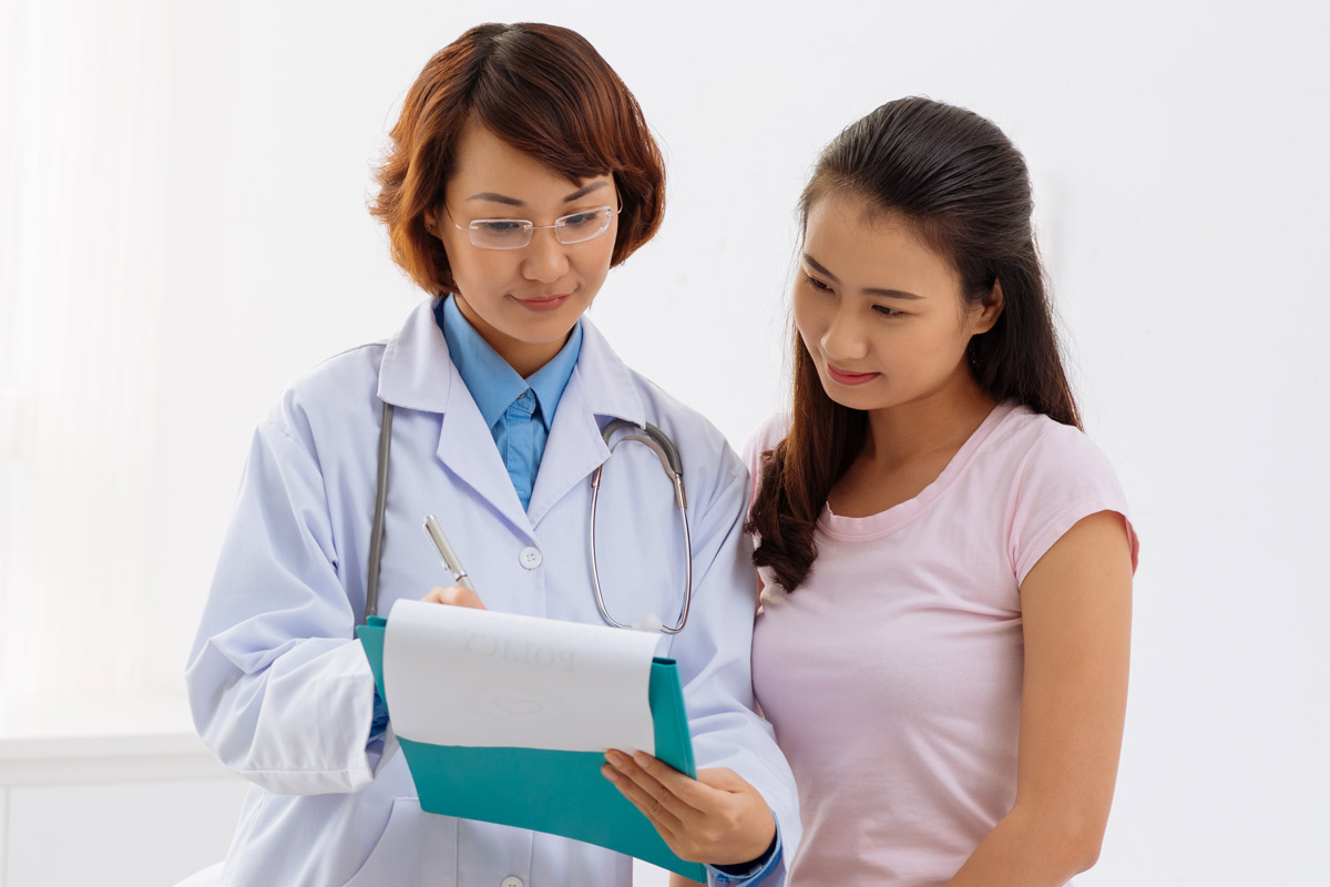 doctor examining a report with her patient