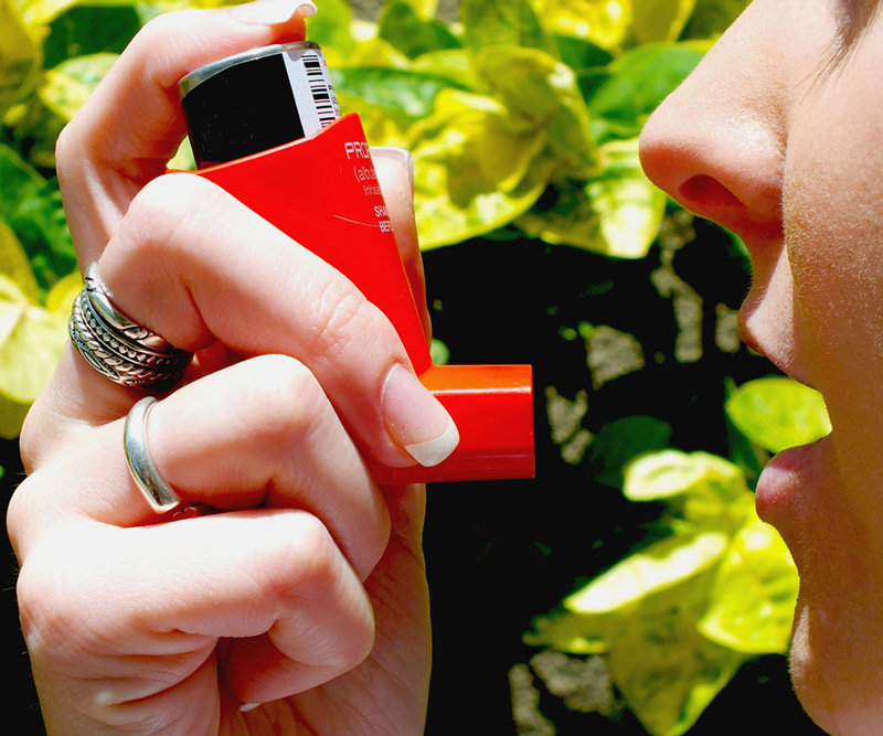 woman using an inhaler