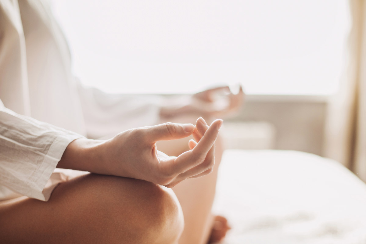 woman meditating in bed