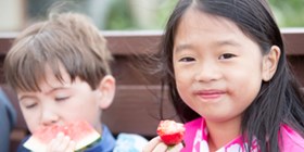 two children eating fruits