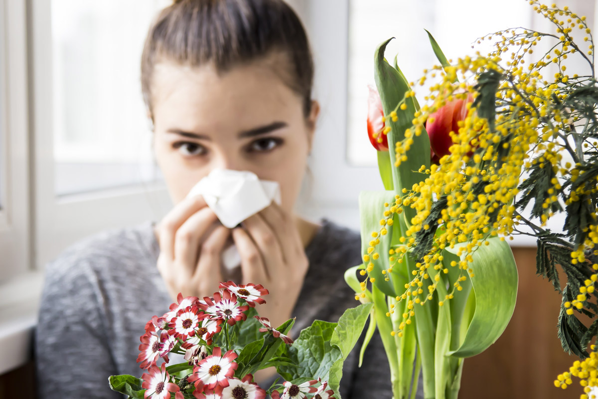 woman blowing her nose into a tissue