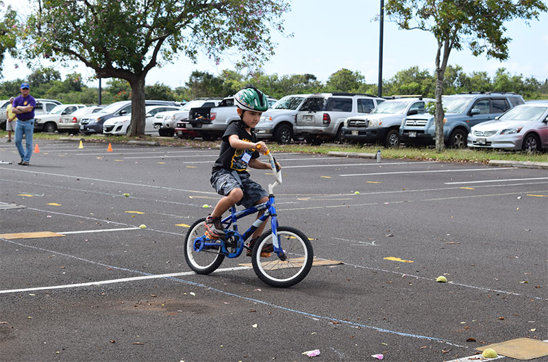 Photo of a keiki riding a bike.