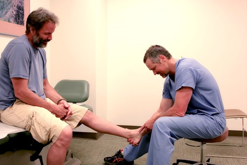 Dr. Daniel Judd examines a patient's ankle to make sure everything is in proper working order.