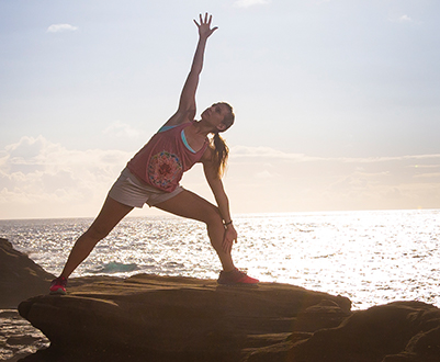 woman doing yoga at sunrise