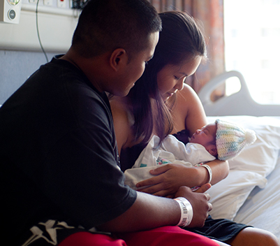 Mother and father holding newborn baby