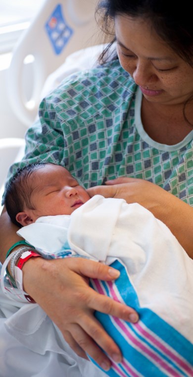 women holding her new born child