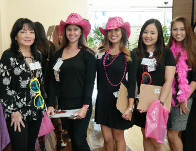 5 women with pink hats and accessories