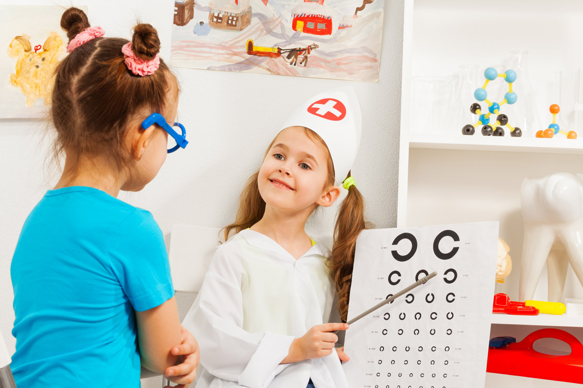 two young girls playing role play as doctor and patient