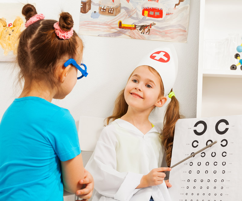 two young girls playing role play as doctor and patient